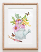 Framed art print featuring a vintage watering can filled with echinacea flowers, kumquats, eucalyptus leaves, and surrounded by monarch butterflies, perfect for farmhouse kitchen decor.